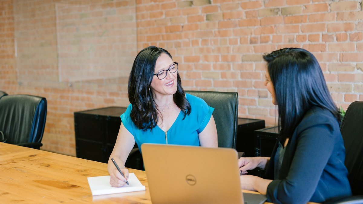 Marketing team reviewing campaign notes and customer follow-up ideas at a table.